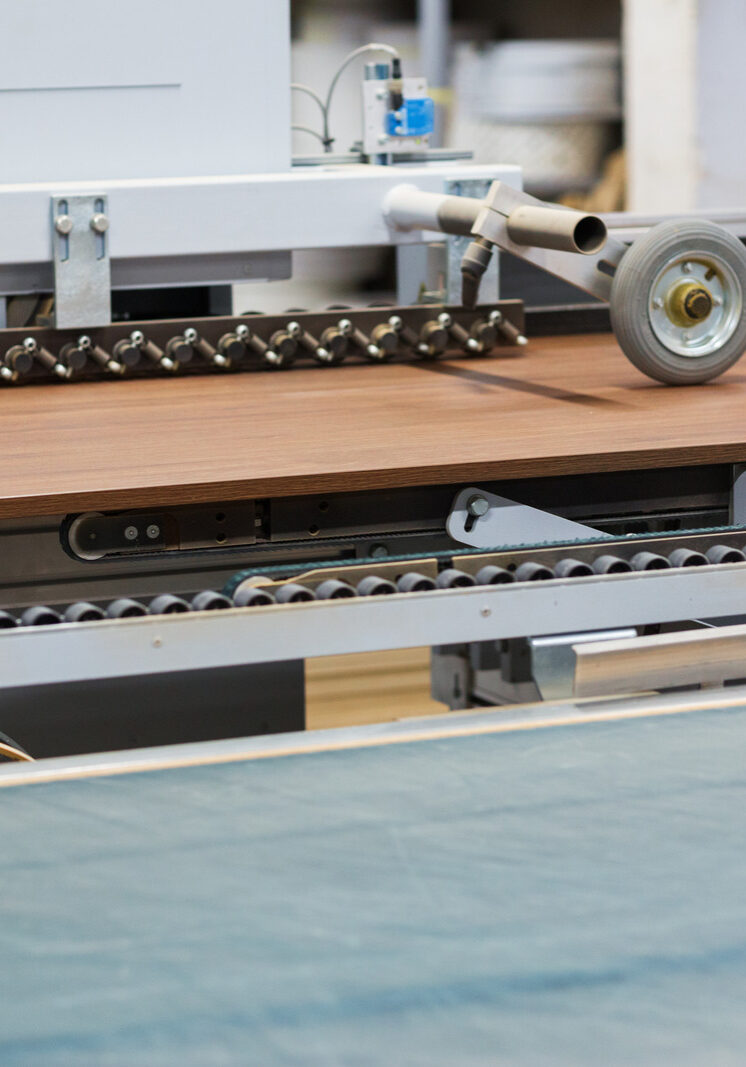 production, manufacture and woodworking industry concept - chipboards processing on conveyer at furniture factory workshop