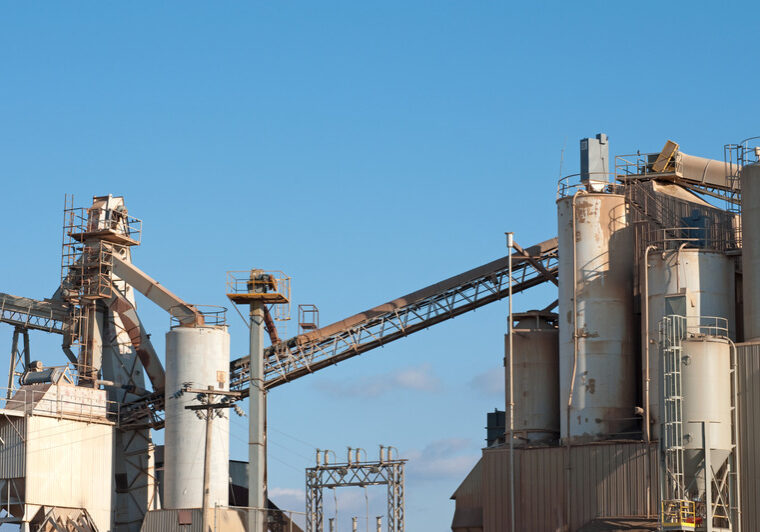 "A pre-formed concrete cement plant with silos, elevators, and conveyors."