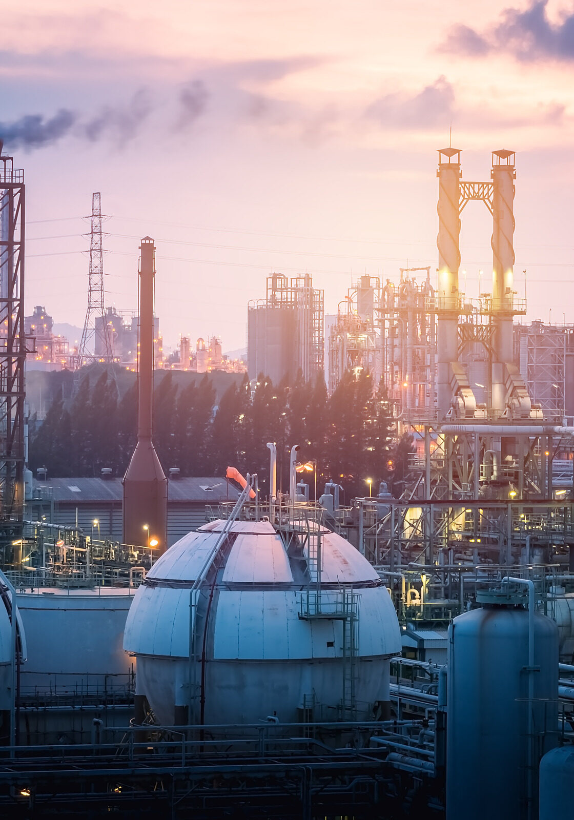 Gas storage sphere tanks in petrochemical industry or oil and gas refinery plant at evening